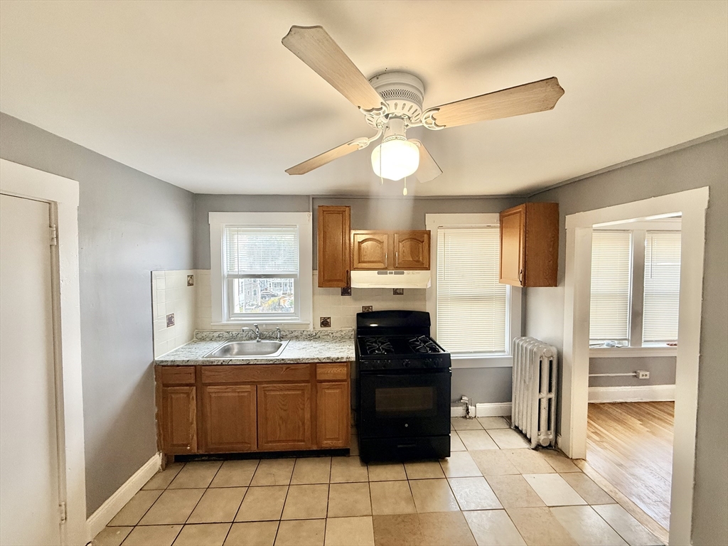 39 Wentworth Street, Unit 3 Boston, MA 02124 - Photo 8 of 19 a kitchen with a stove a sink and a refrigerator