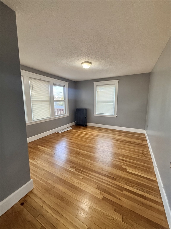 39 Wentworth Street, Unit 3 Boston, MA 02124 - Photo 9 of 19 a view of empty room with wooden floor and fan