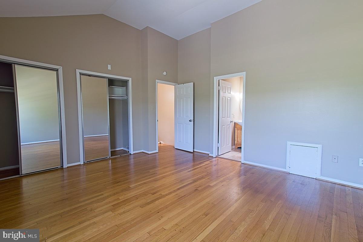 9054 Canterbury Riding, Unit 147 Laurel, MD 20723 - Photo 8 of 15 a view of an empty room with wooden floor and closet