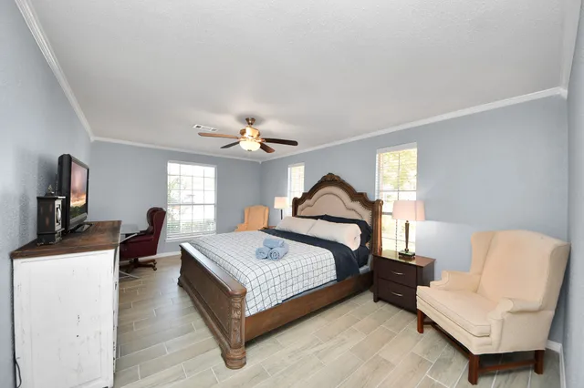 a bed room with a bed couch and a window