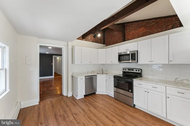 a kitchen with stainless steel appliances granite countertop a stove sink and cabinets