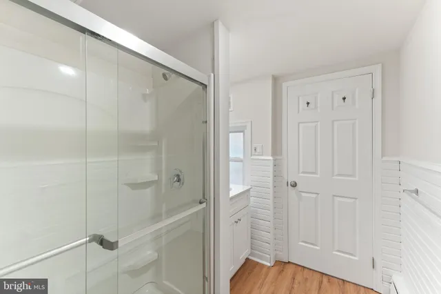 a bathroom with a shower and a glass door
