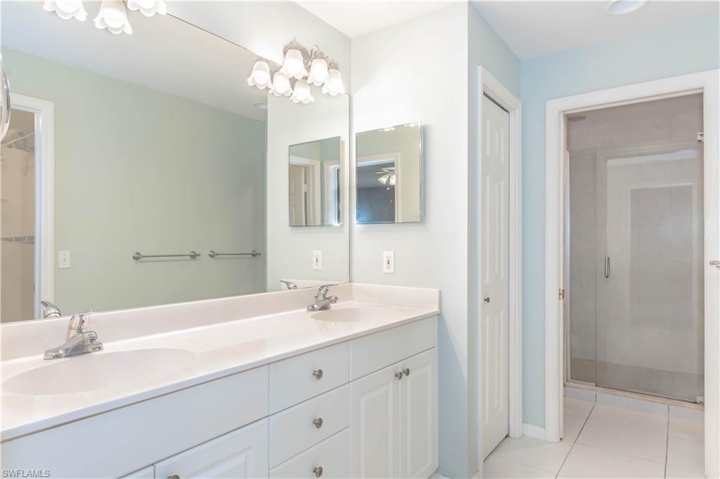 11153 San Sebastian Lane Bonita Springs, FL 34135 - Photo 12 of 25 a bathroom with a double vanity sink and a mirror
