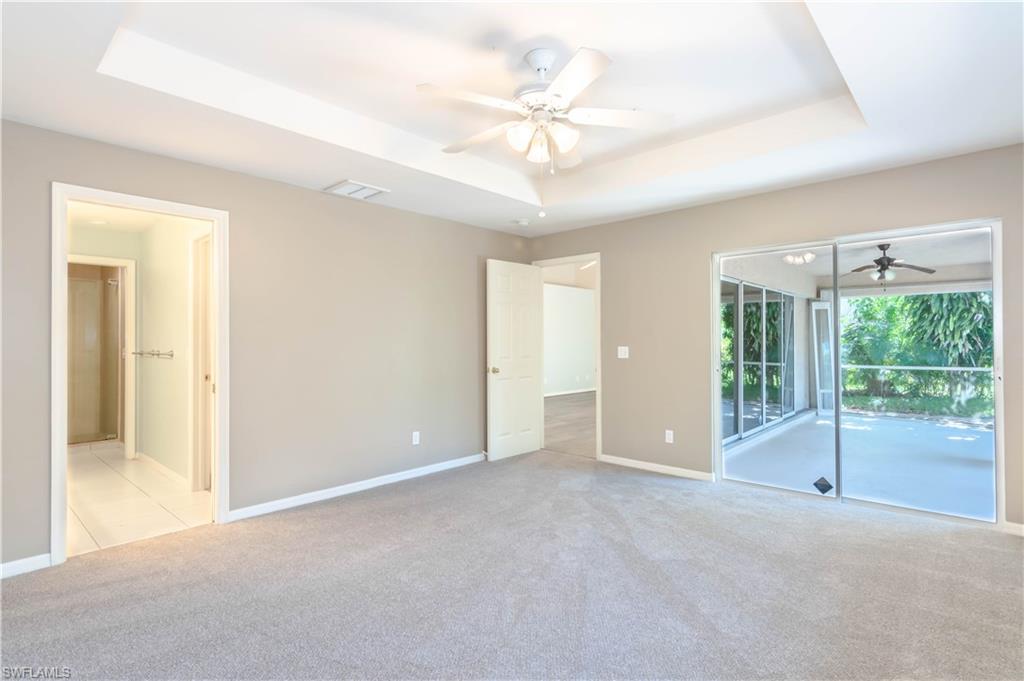 11153 San Sebastian Lane Bonita Springs, FL 34135 - Photo 14 of 25 a view of an empty room with glass door and a ceiling fan