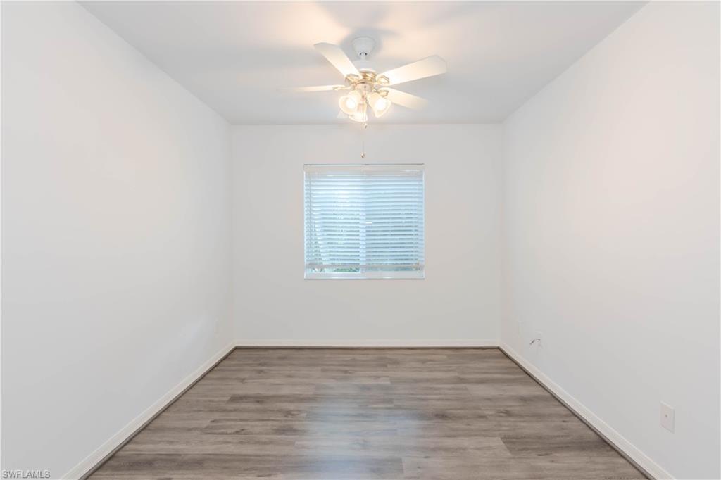 11153 San Sebastian Lane Bonita Springs, FL 34135 - Photo 16 of 25 wooden floor in an empty room with a window