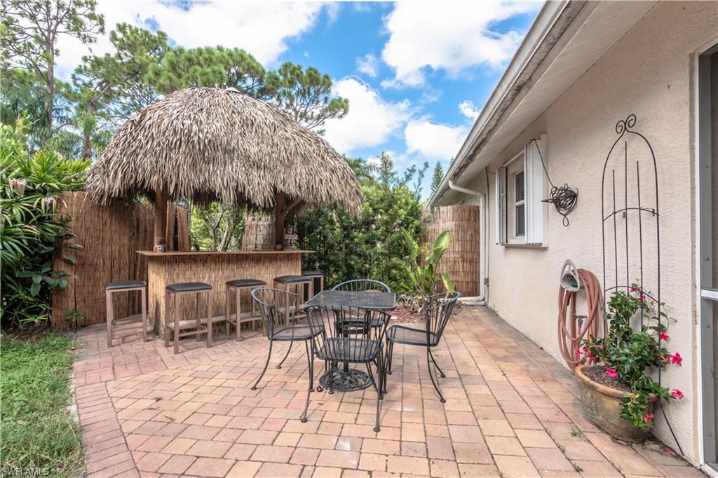 11153 San Sebastian Lane Bonita Springs, FL 34135 - Photo 2 of 25 a view of a patio with a table and chairs and potted plants