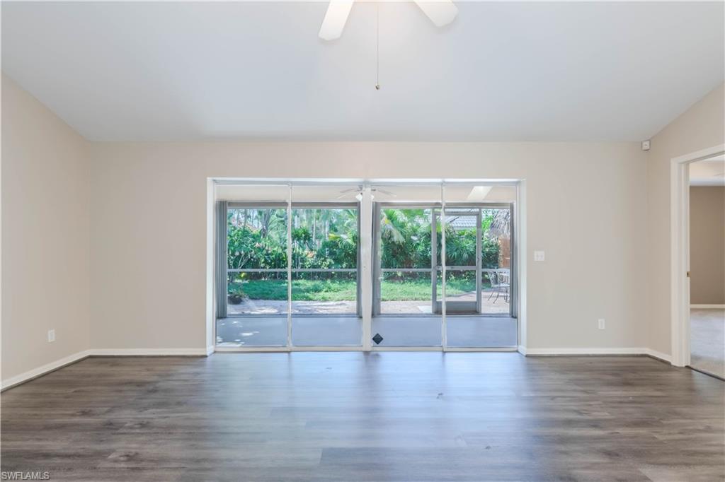 11153 San Sebastian Lane Bonita Springs, FL 34135 - Photo 5 of 25 a view of an empty room with wooden floor and a window