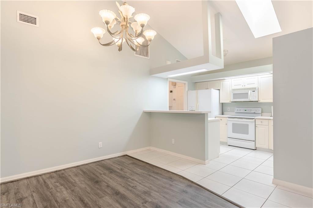11153 San Sebastian Lane Bonita Springs, FL 34135 - Photo 6 of 25 a kitchen with granite countertop white cabinets and stainless steel appliances