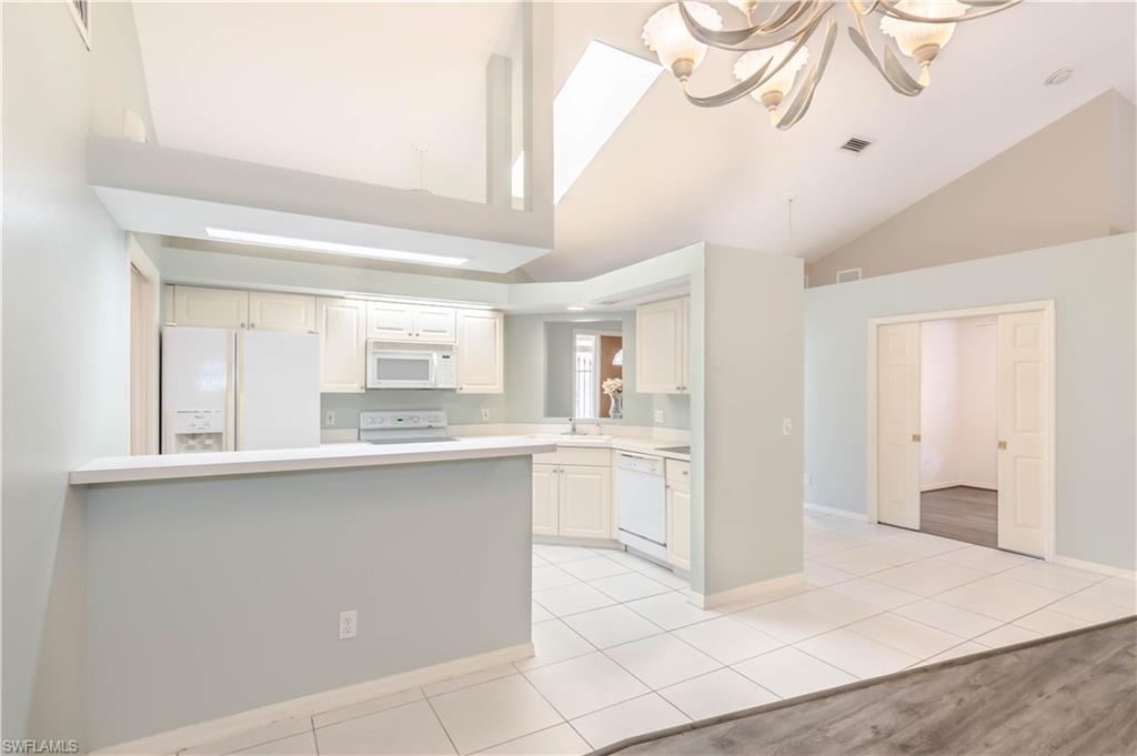 11153 San Sebastian Lane Bonita Springs, FL 34135 - Photo 7 of 25 a large white kitchen with cabinets