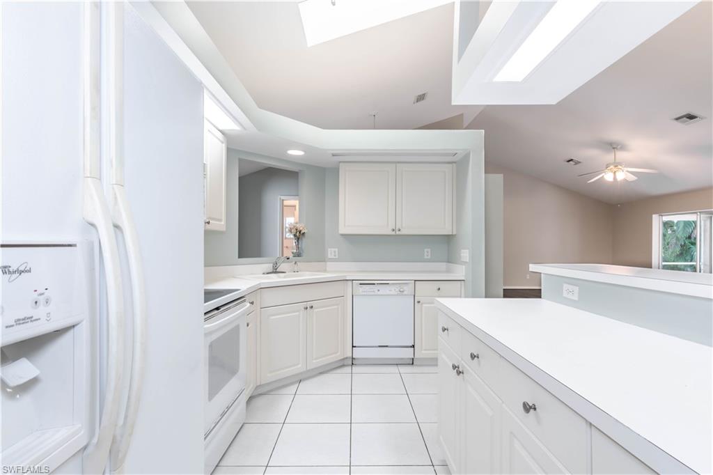11153 San Sebastian Lane Bonita Springs, FL 34135 - Photo 10 of 25 a large white kitchen with a sink and cabinets