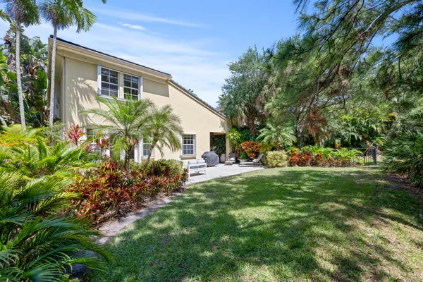 a view of backyard with seating area and green space