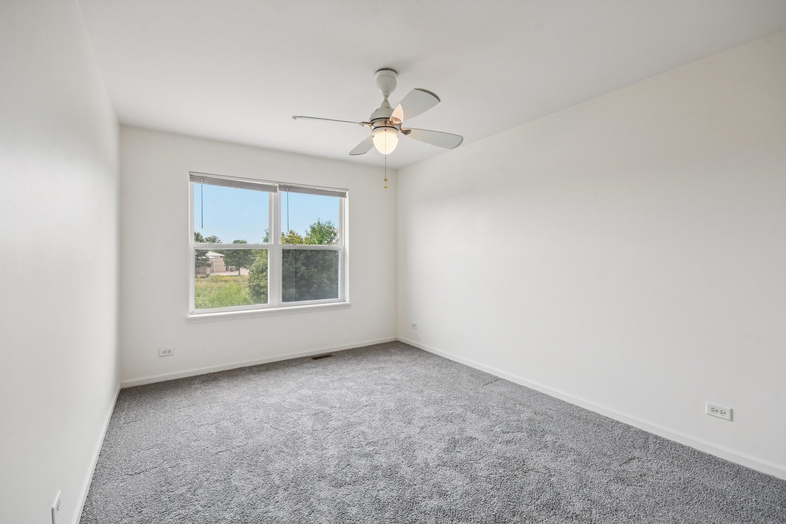 2486 Georgetown Circle Aurora, IL 60503 - Photo 15 of 26 an empty room with windows and fan