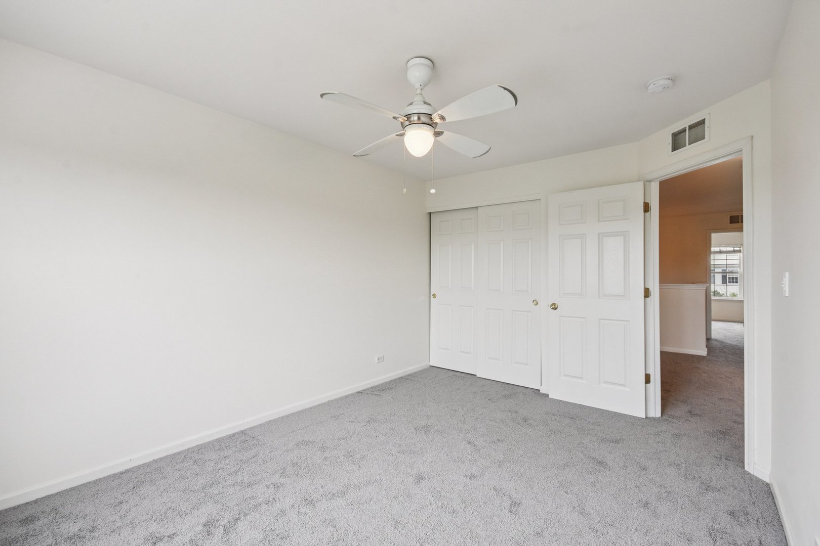 2486 Georgetown Circle Aurora, IL 60503 - Photo 16 of 26 an empty room with closet and a ceiling fan