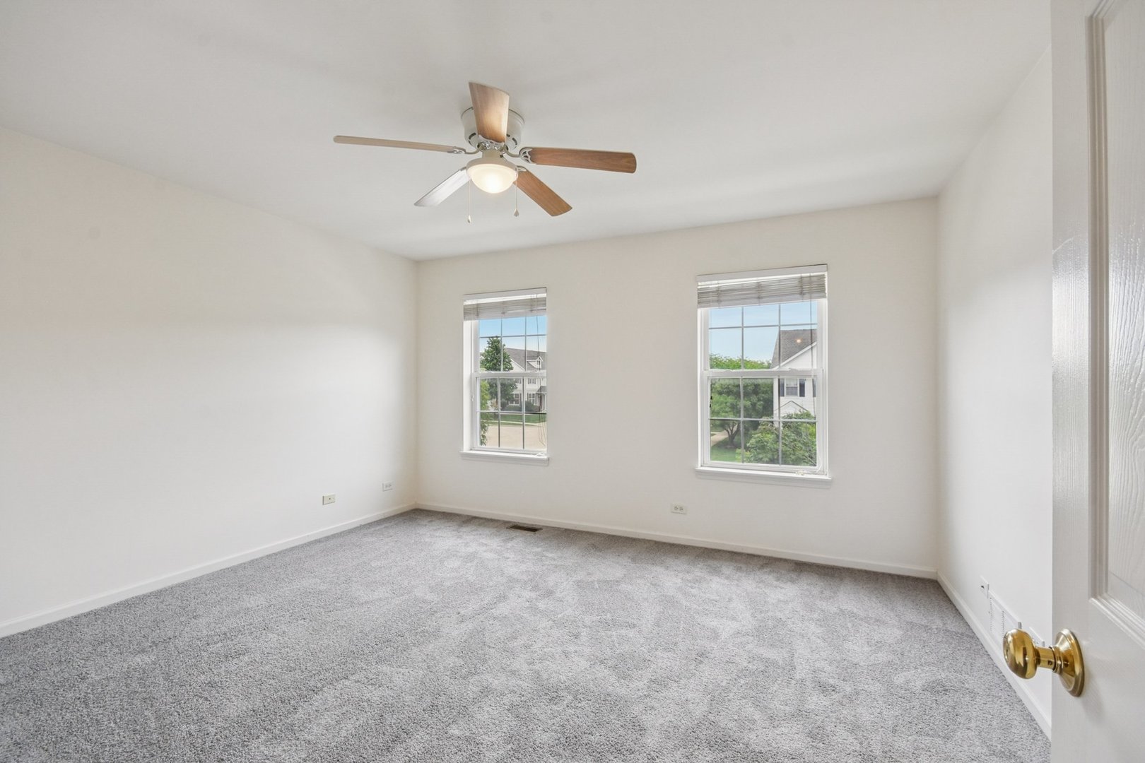2486 Georgetown Circle Aurora, IL 60503 - Photo 20 of 26 an empty room with windows and fan
