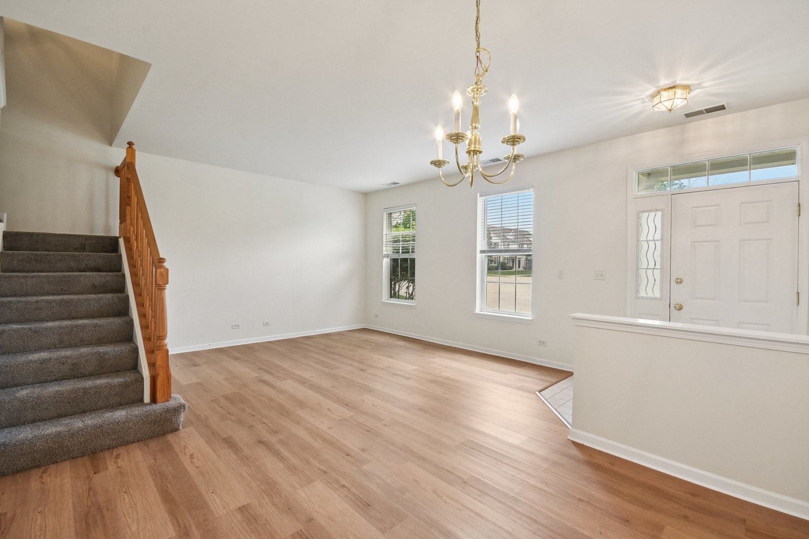 2486 Georgetown Circle Aurora, IL 60503 - Photo 4 of 26 a view of an empty room with wooden floor and a window