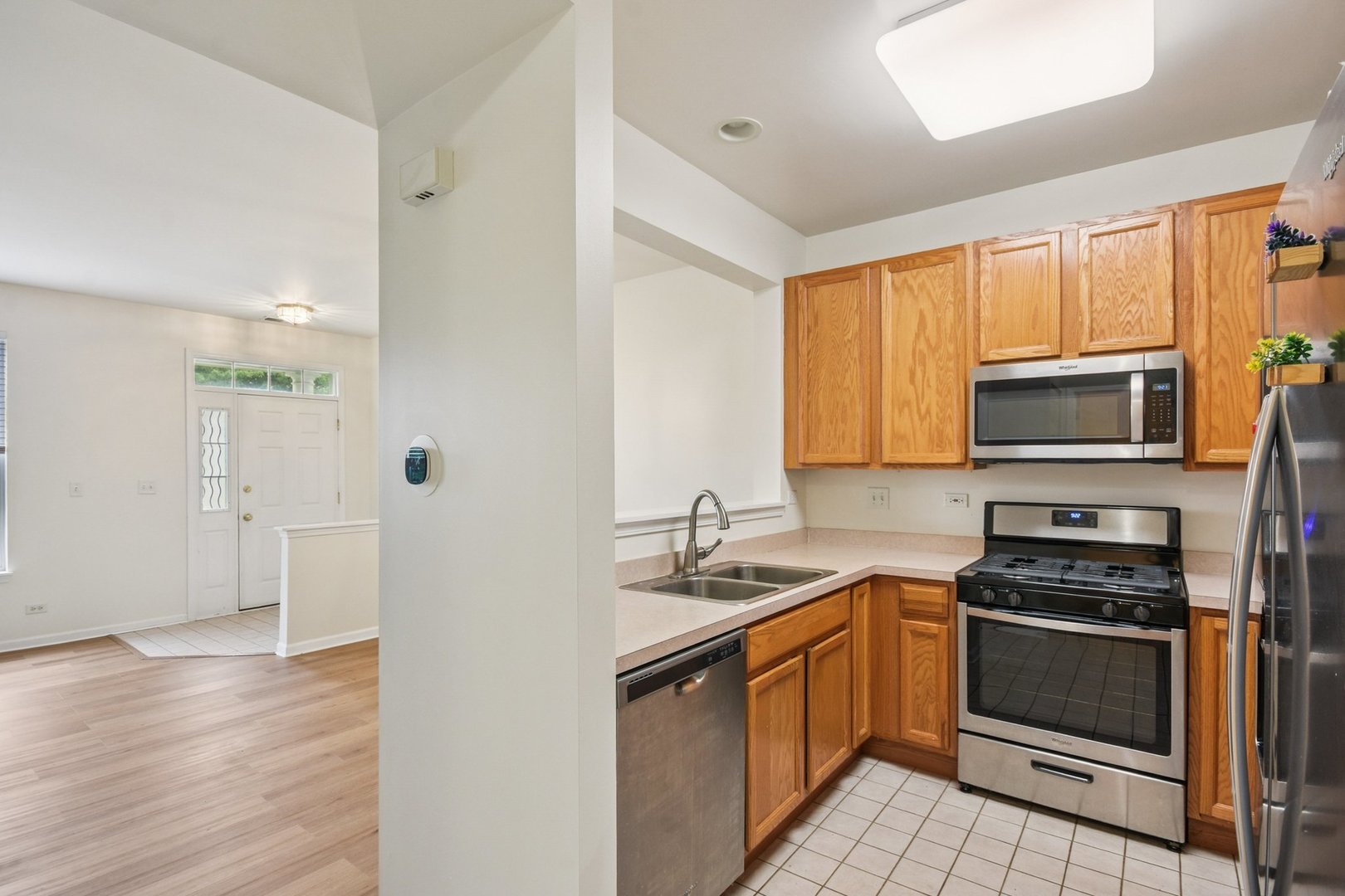 2486 Georgetown Circle Aurora, IL 60503 - Photo 9 of 26 a kitchen with stainless steel appliances a stove sink and microwave