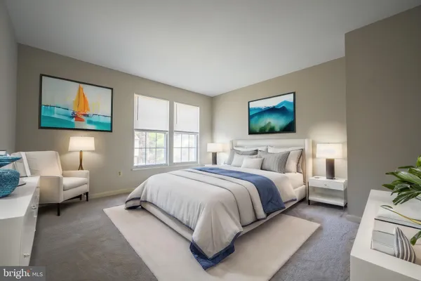a spacious bedroom with a bed couch and window