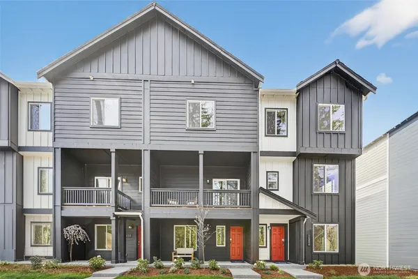 a front view of a residential apartment building with a yard