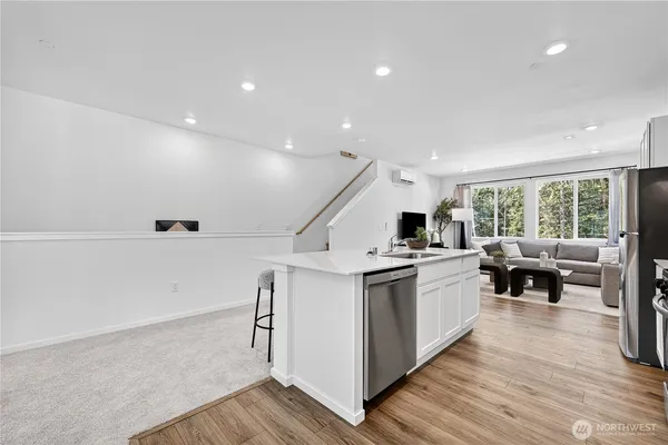 a kitchen with a sink stainless steel appliances and window