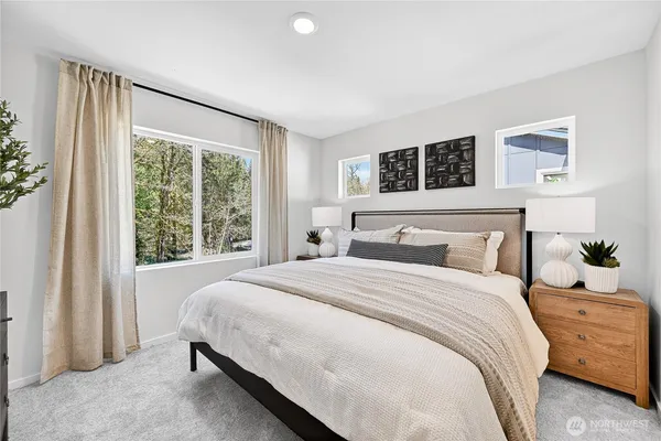 a bedroom with a large bed and a window