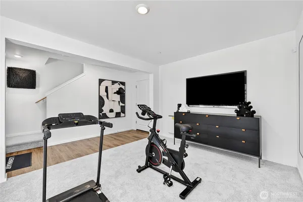 a view of a workspace with furniture and a flat screen tv