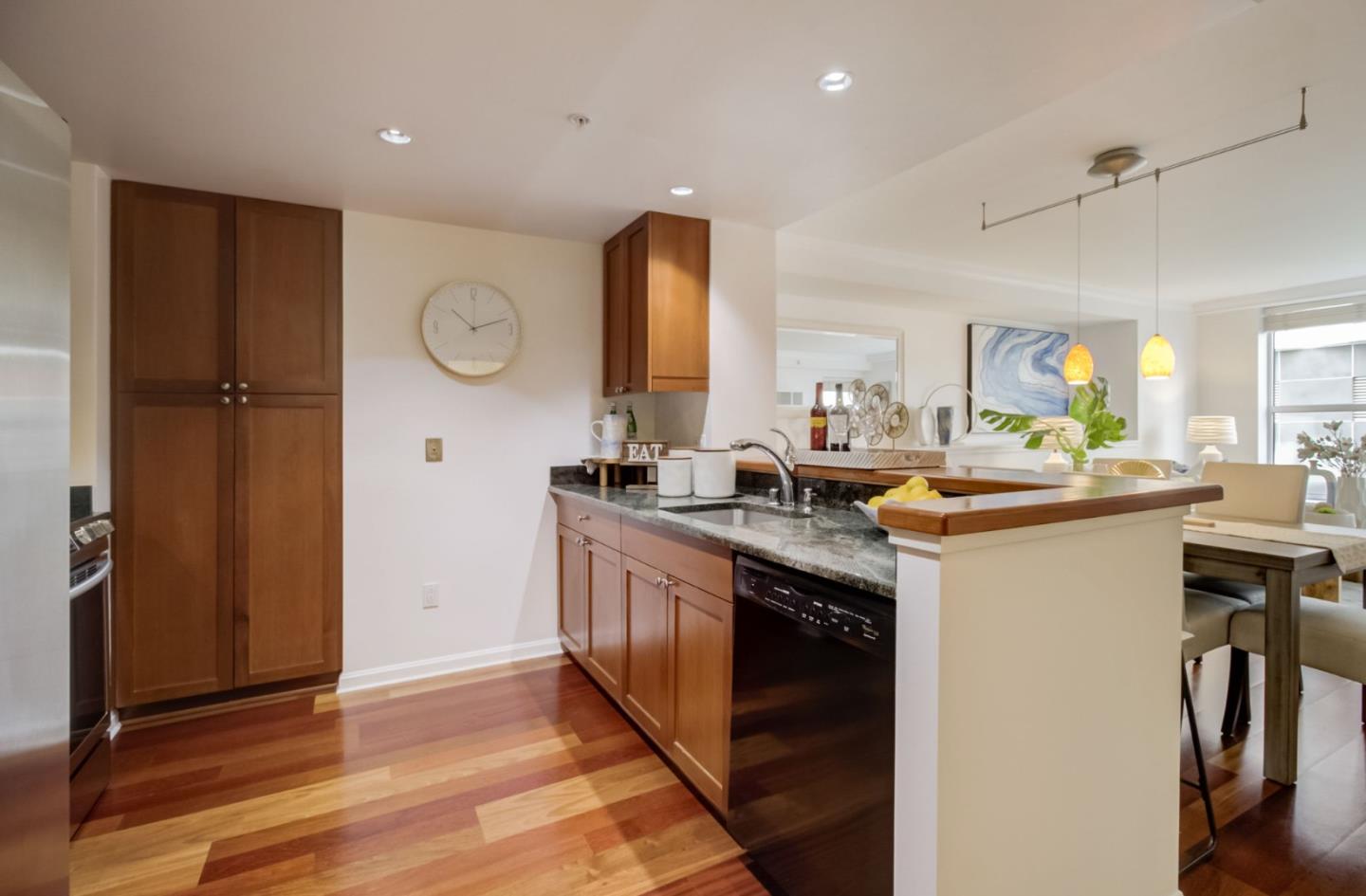 400 Beale Street, Unit 612 San Francisco, CA 94105 - Photo 11 of 38 a kitchen with a sink cabinets and wooden floor