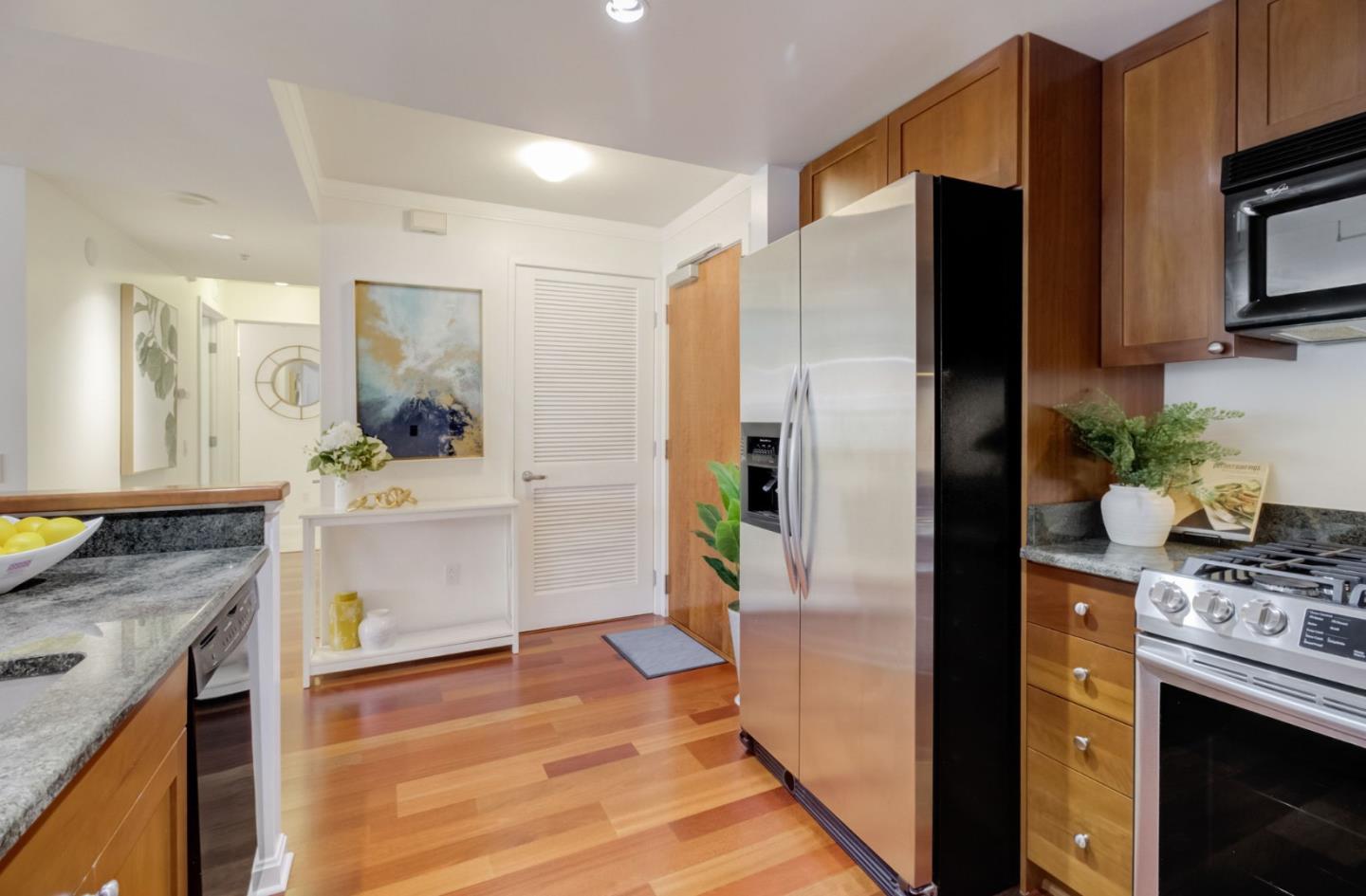 400 Beale Street, Unit 612 San Francisco, CA 94105 - Photo 12 of 38 a kitchen with a refrigerator stove and sink