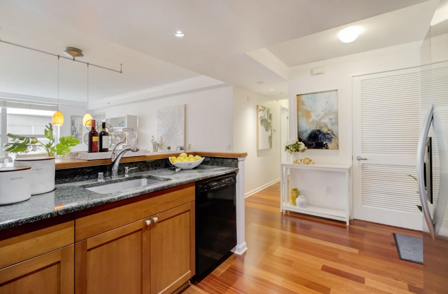 400 Beale Street, Unit 612 San Francisco, CA 94105 - Photo 13 of 38 a kitchen with a refrigerator and white cabinets