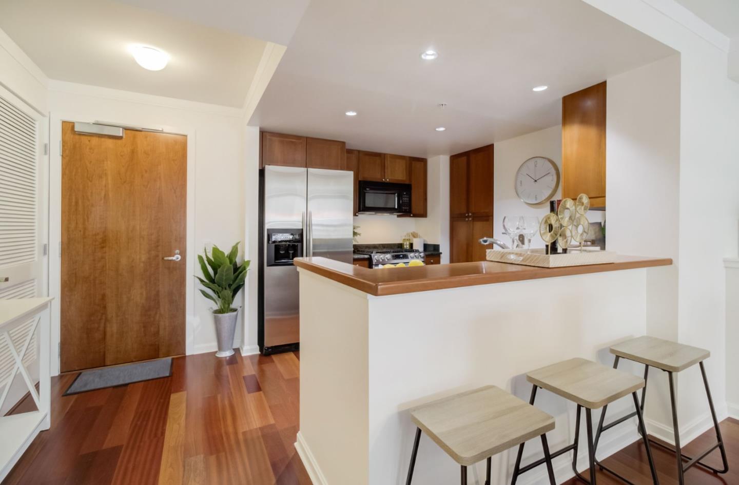 400 Beale Street, Unit 612 San Francisco, CA 94105 - Photo 14 of 38 a kitchen with stainless steel appliances kitchen island granite countertop a stove a sink and a refrigerator