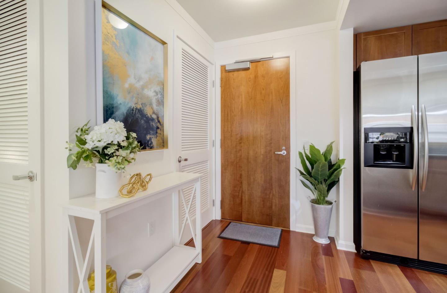 400 Beale Street, Unit 612 San Francisco, CA 94105 - Photo 15 of 38 a view of a hallway to a livingroom with wooden floor and a dining table