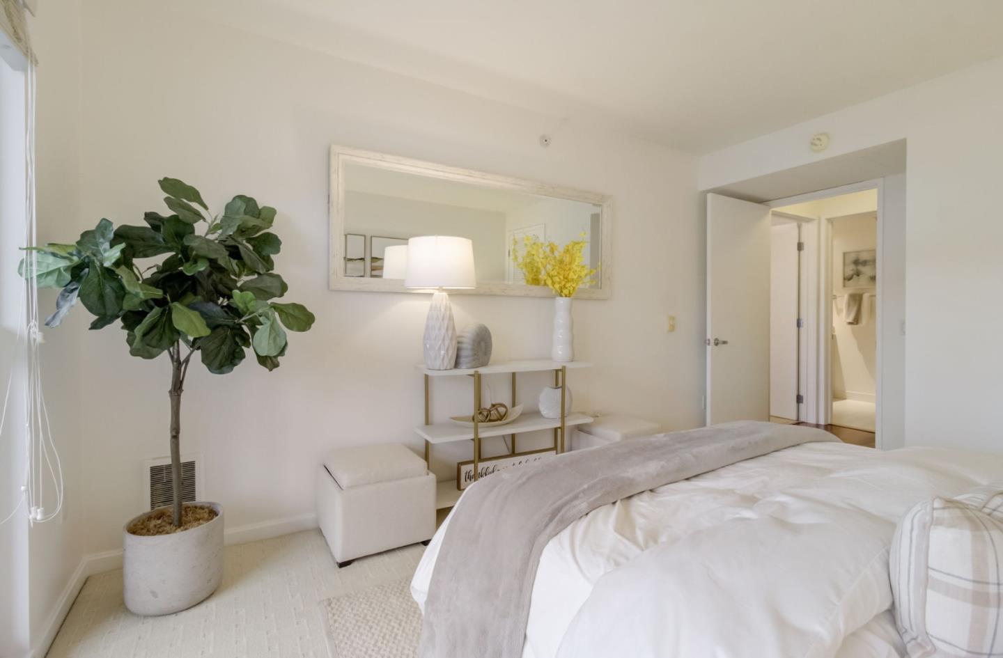 400 Beale Street, Unit 612 San Francisco, CA 94105 - Photo 18 of 38 a bedroom with a bed potted plant and a potted plant