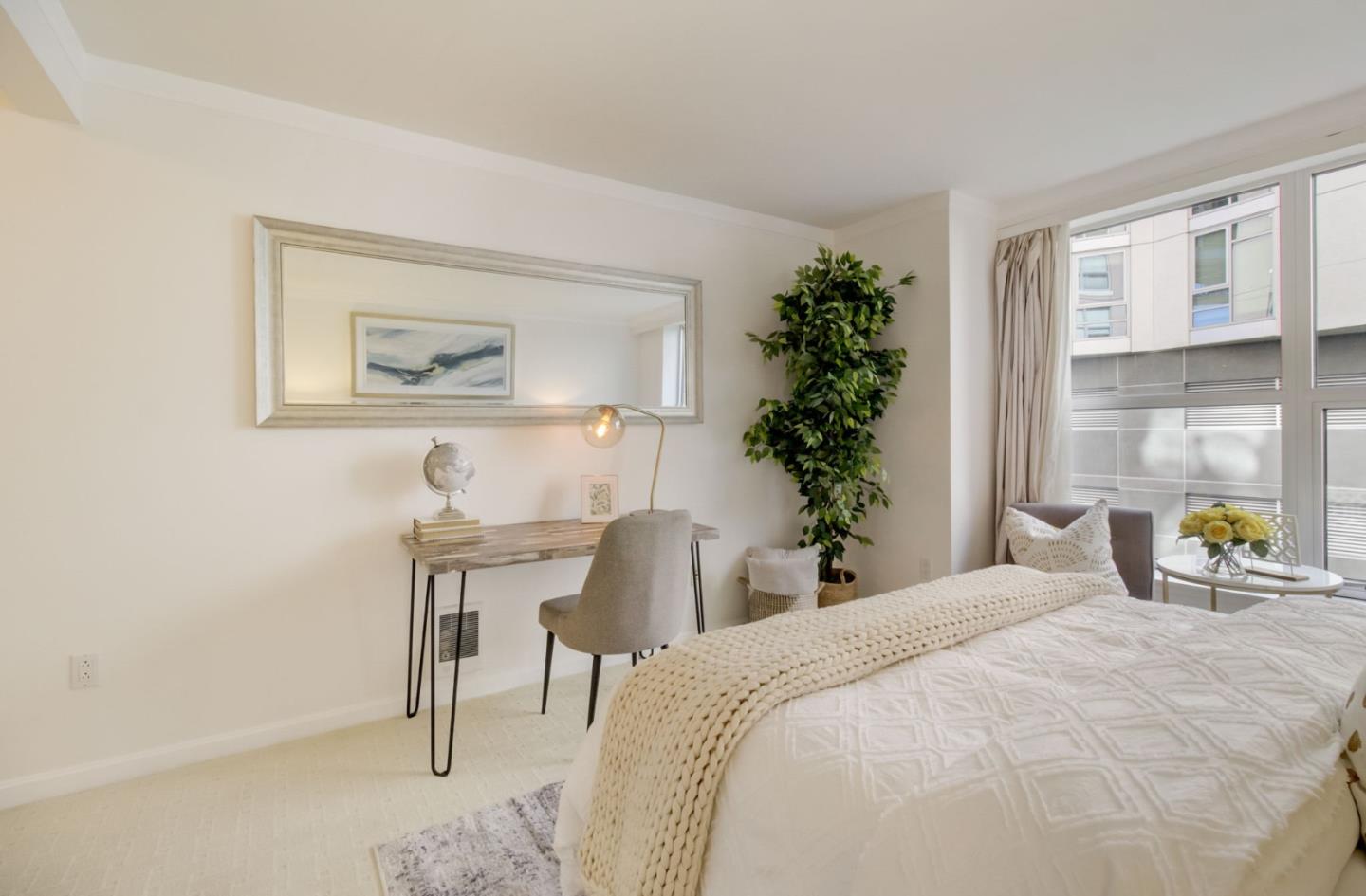 400 Beale Street, Unit 612 San Francisco, CA 94105 - Photo 22 of 38 a bedroom with a bed and a potted plant