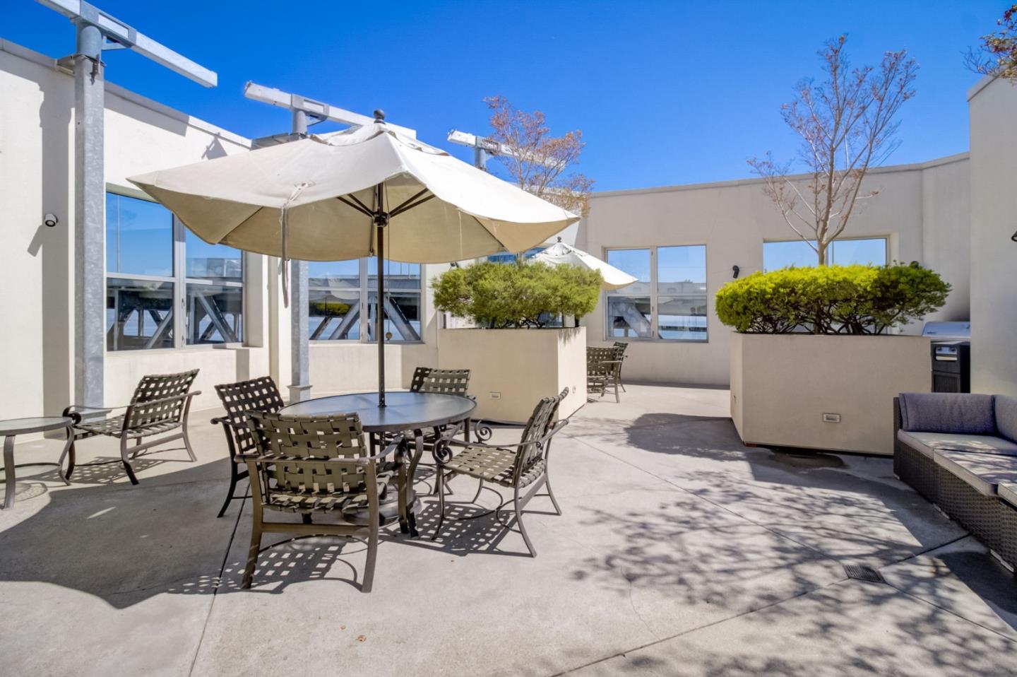 400 Beale Street, Unit 612 San Francisco, CA 94105 - Photo 29 of 38 a view of a patio with a table and chairs under an umbrella