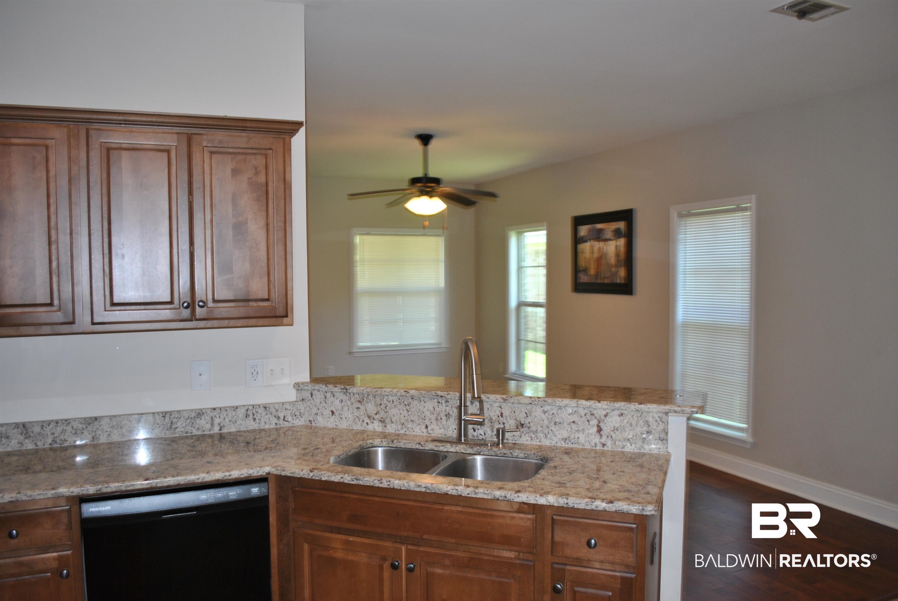 2161 Spring Grove West Mobile, AL 36695 - Photo 14 of 31 Kitchen featuring dishwasher, a peninsula, dark wood-style flooring, light stone countertops, and a ceiling fan