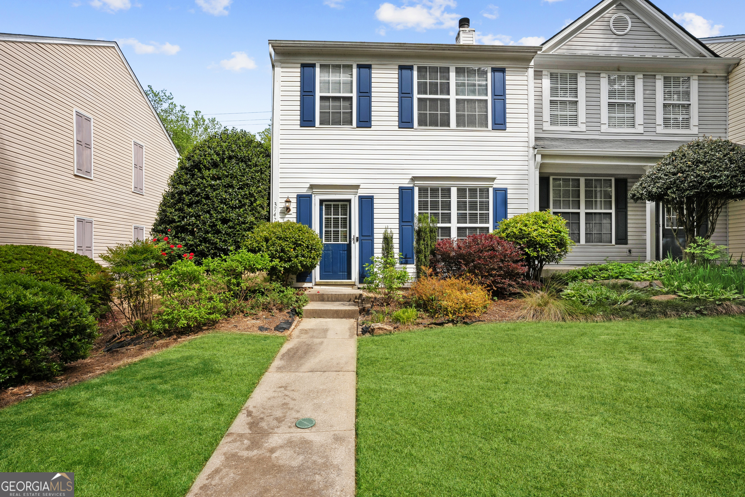 a front view of a house with a yard and porch