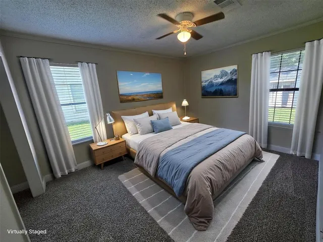 a bedroom with a large bed and a window