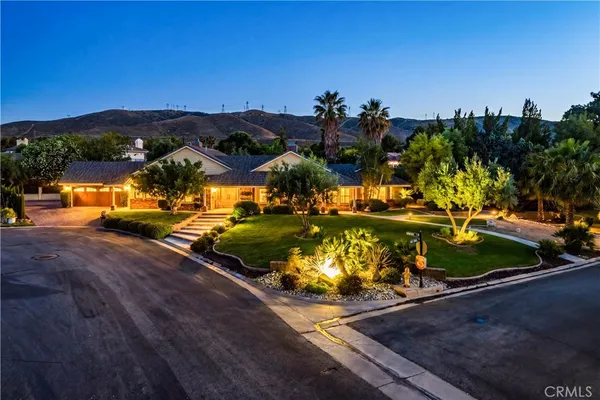 an aerial view of a house with a garden and houses