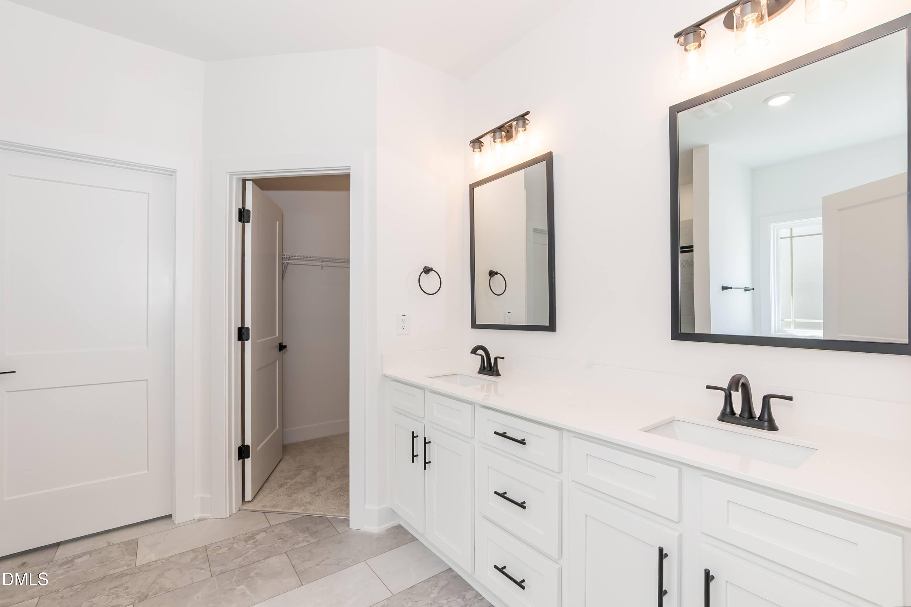 180 Galway Road Lillington, NC 27546 - Photo 24 of 41 a bathroom with double sink and a mirror