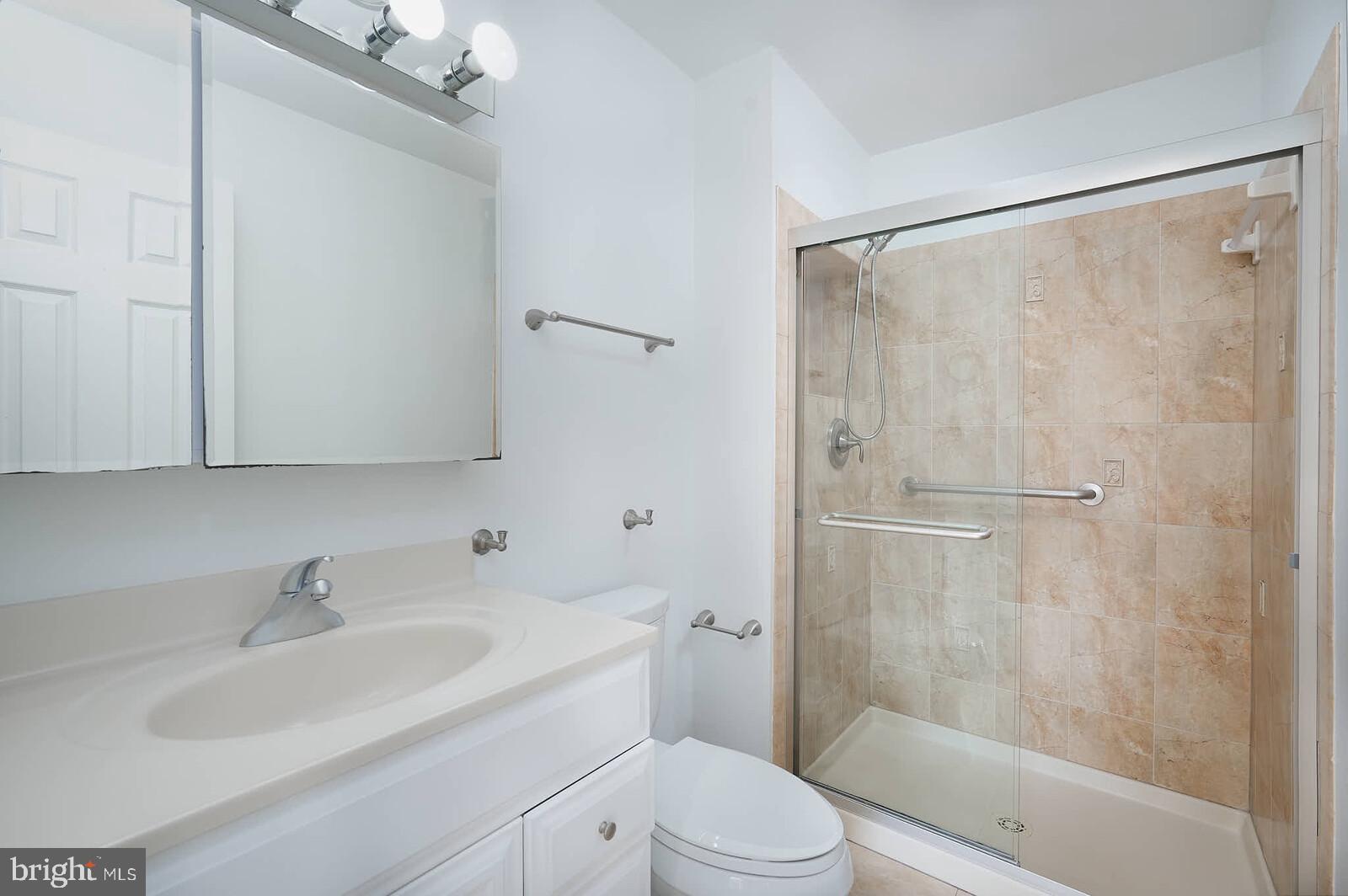 10246 Arizona Circle, Unit 36 Bethesda, MD 20817 - Photo 15 of 30 a bathroom with a sink toilet and shower