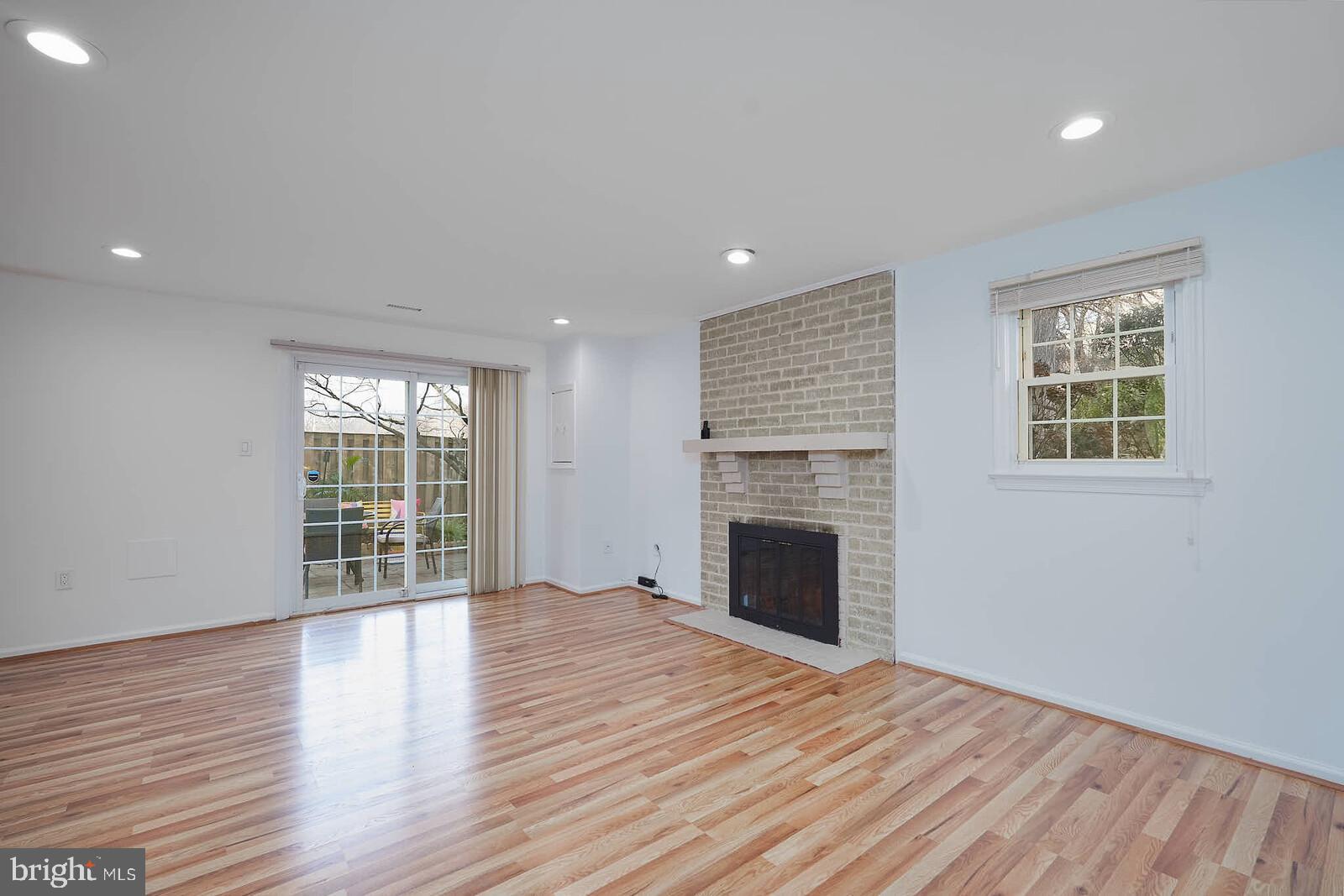 10246 Arizona Circle, Unit 36 Bethesda, MD 20817 - Photo 22 of 30 an empty room with wooden floor and a fireplace