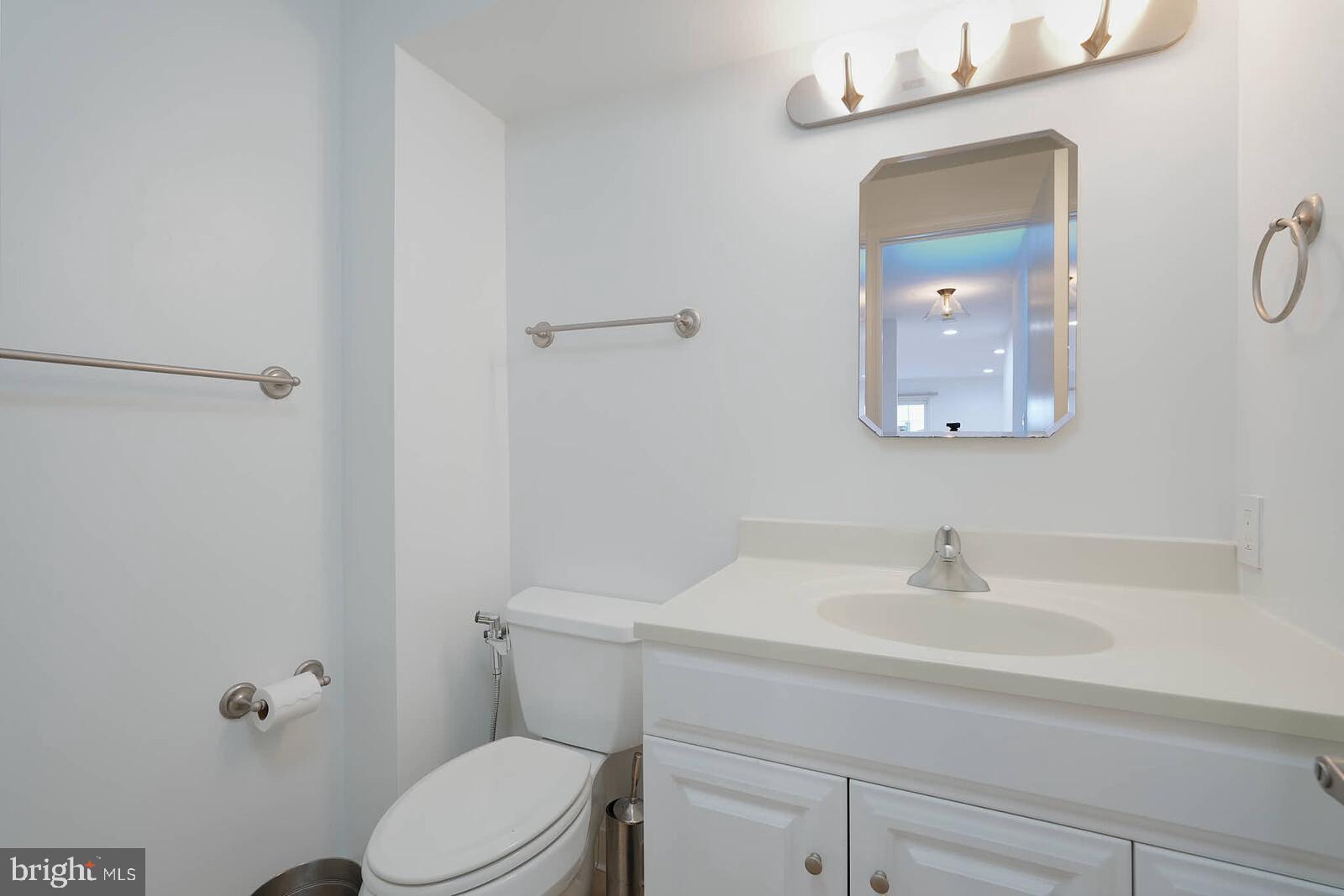 10246 Arizona Circle, Unit 36 Bethesda, MD 20817 - Photo 27 of 30 a bathroom with a sink a toilet and shower