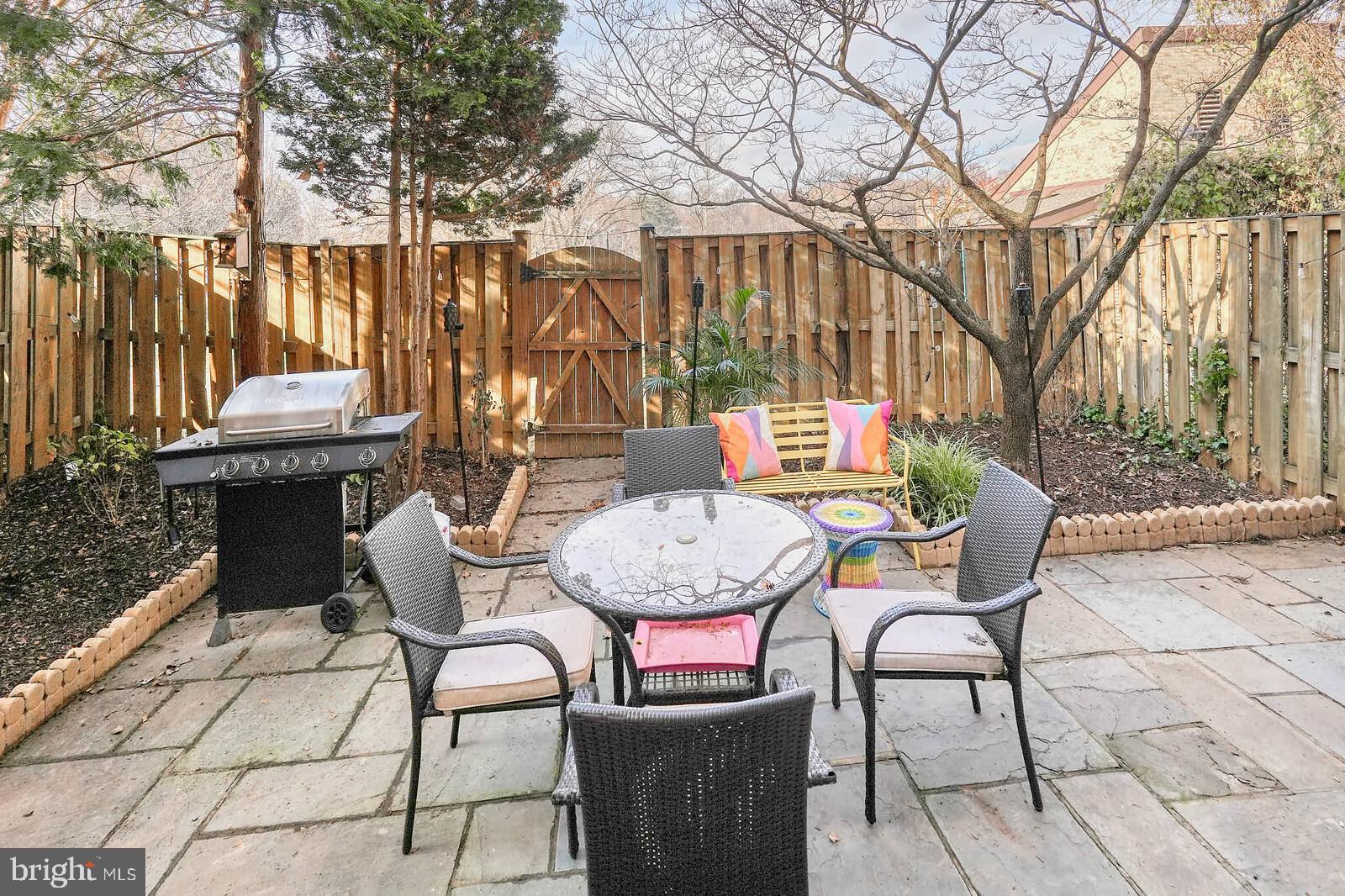 10246 Arizona Circle, Unit 36 Bethesda, MD 20817 - Photo 28 of 30 a view of a chairs and tables in the back yard of the house