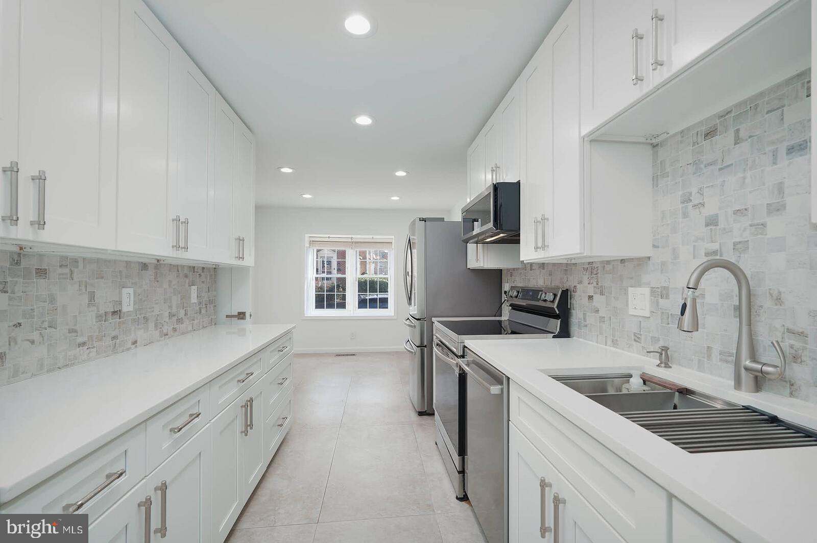 10246 Arizona Circle, Unit 36 Bethesda, MD 20817 - Photo 7 of 30 a kitchen with a sink stove top oven and cabinets