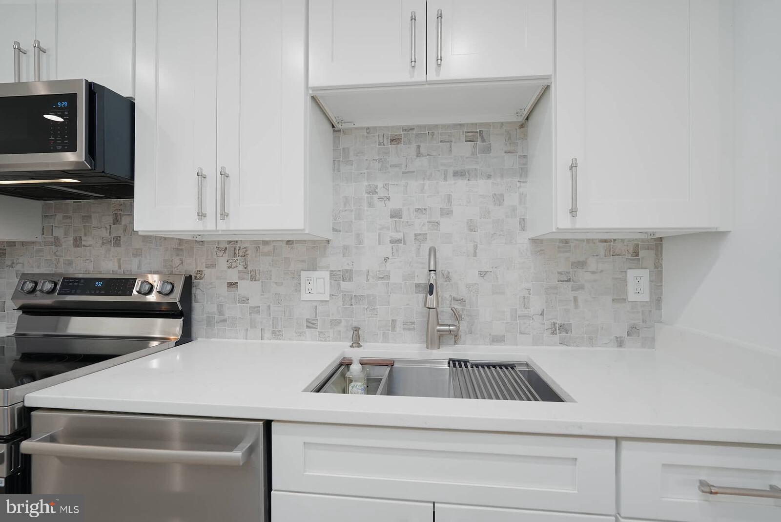10246 Arizona Circle, Unit 36 Bethesda, MD 20817 - Photo 9 of 30 a kitchen with a sink a stove and microwave