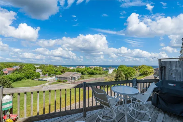 a view of a chairs and table in the balcony