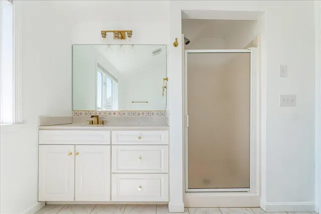 a bathroom with a sink a toilet and a window