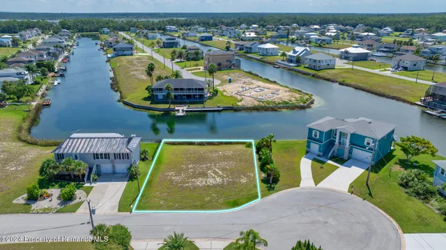 an aerial view of a house with a swimming pool yard and outdoor seating