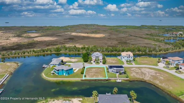 an aerial view of a house with a ocean view