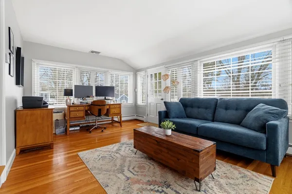 a living room with furniture flat screen tv and a window