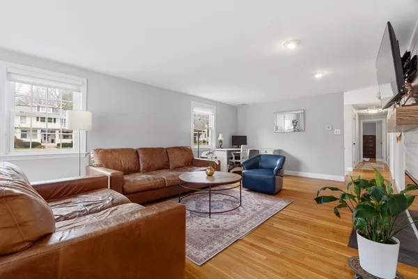 a living room with furniture ceiling fan and a window